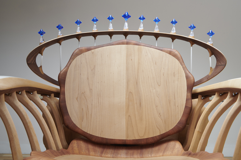 cosmos chair's peculiar design reflects our universe through wooden halos and glass stars