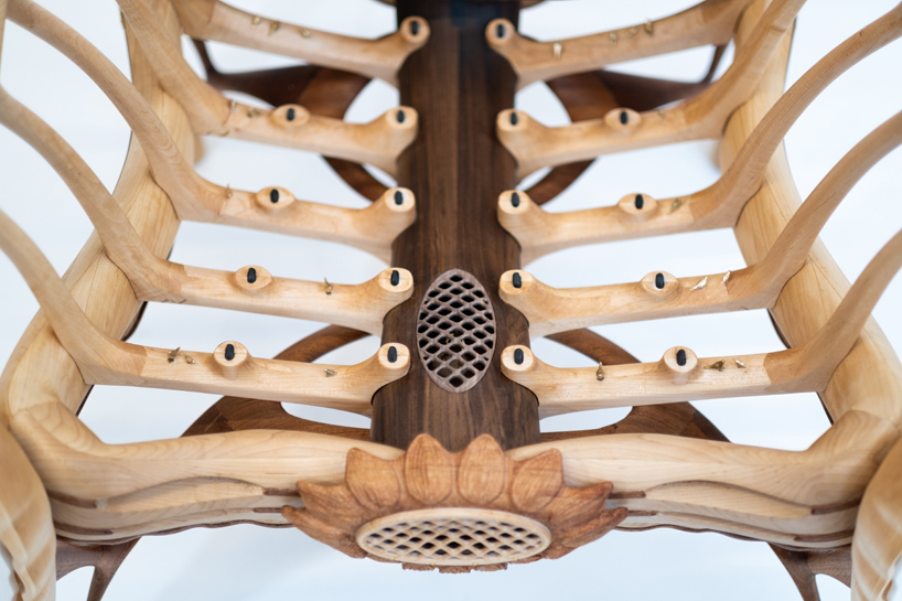cosmos chair's peculiar design reflects our universe through wooden halos and glass stars