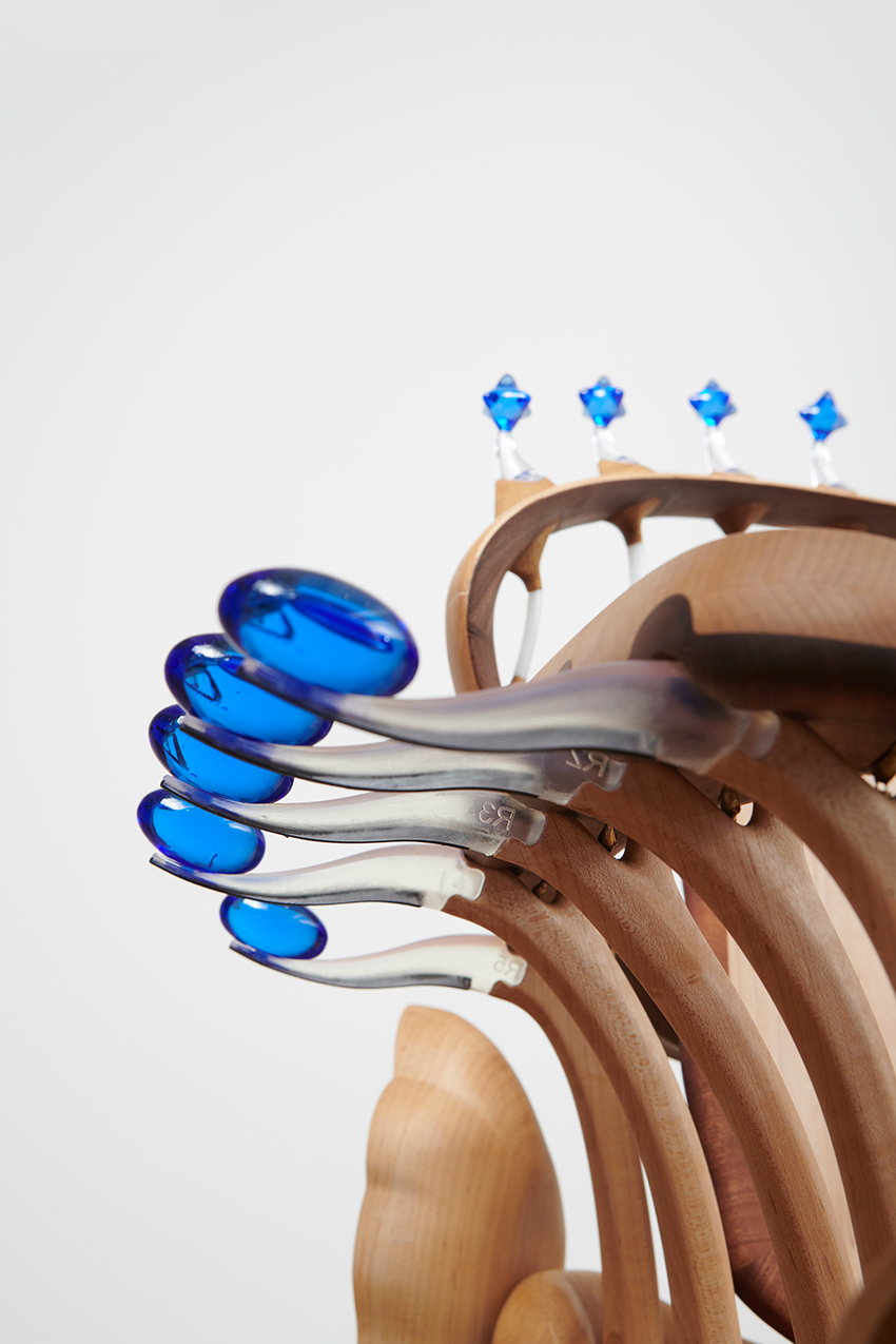 cosmos chair's peculiar design reflects our universe through wooden halos and glass stars