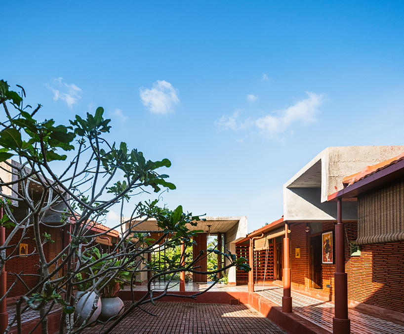 linear brick-laid court organizes weekend home in india reinterpreting 'nalukettu' typology