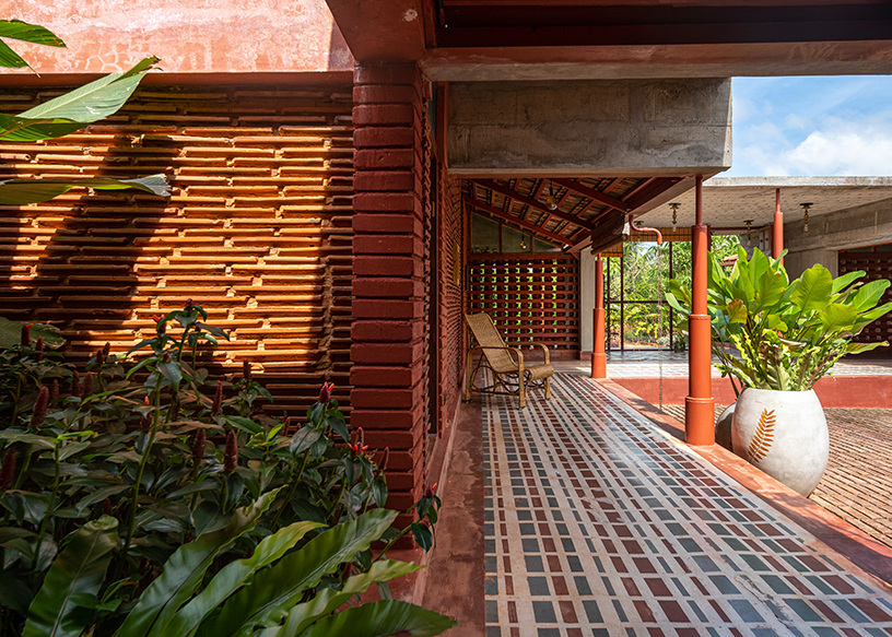 linear brick-laid court organizes weekend home in india reinterpreting 'nalukettu' typology
