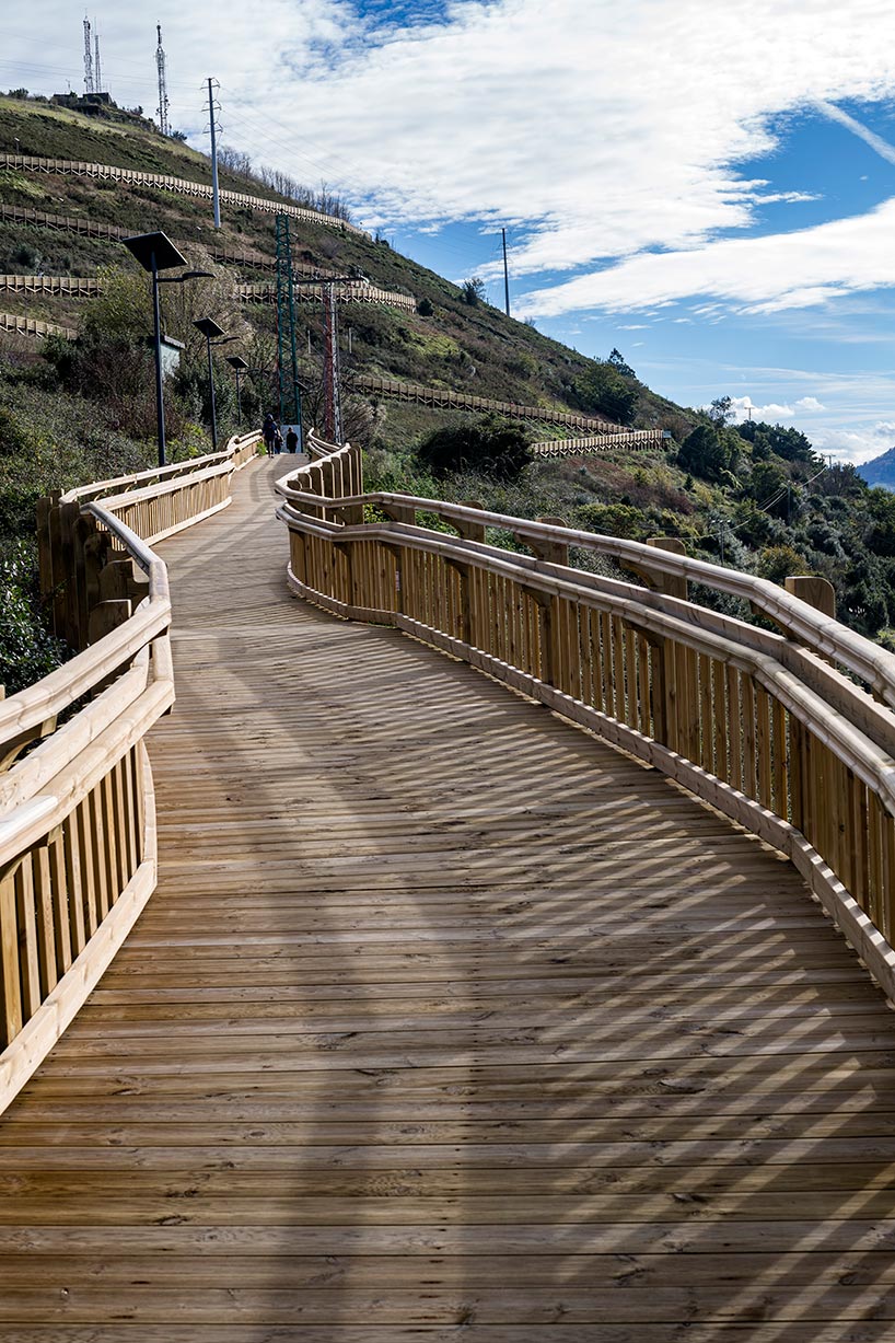 pedestrian wooden walkway on stilts traces hillside in bilbao