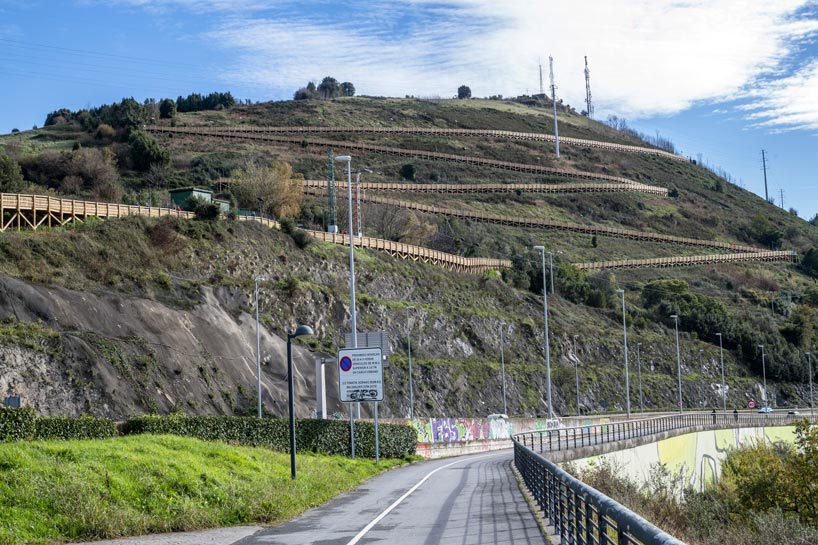 pedestrian wooden walkway on stilts traces hillside in bilbao