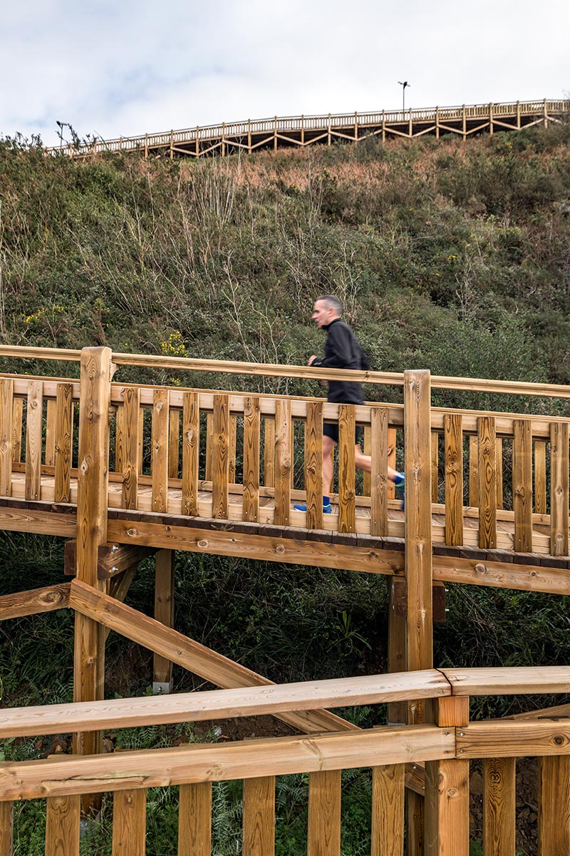 pedestrian wooden walkway on stilts traces hillside in bilbao