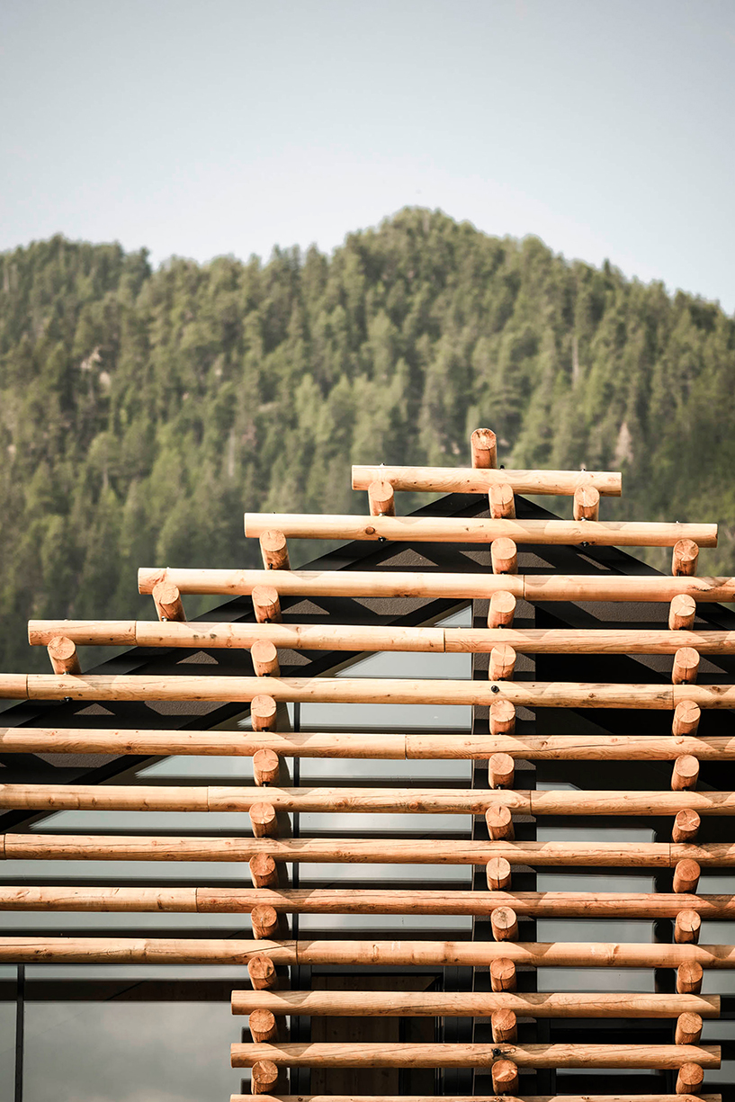 DEAR studio adapts old hay barns into modern larch log-clad hotel in italian alps