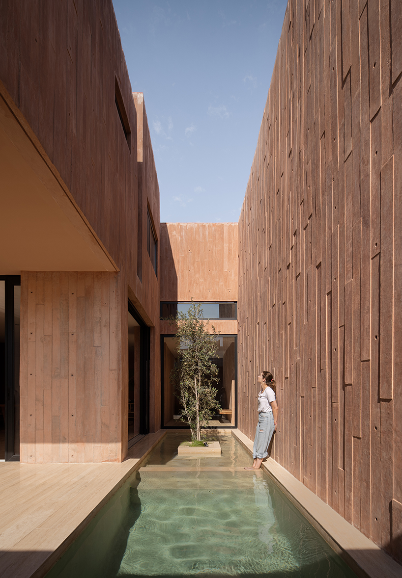 jorge garibay configures brutalist house in mexico as tetris-like pink concrete volumes