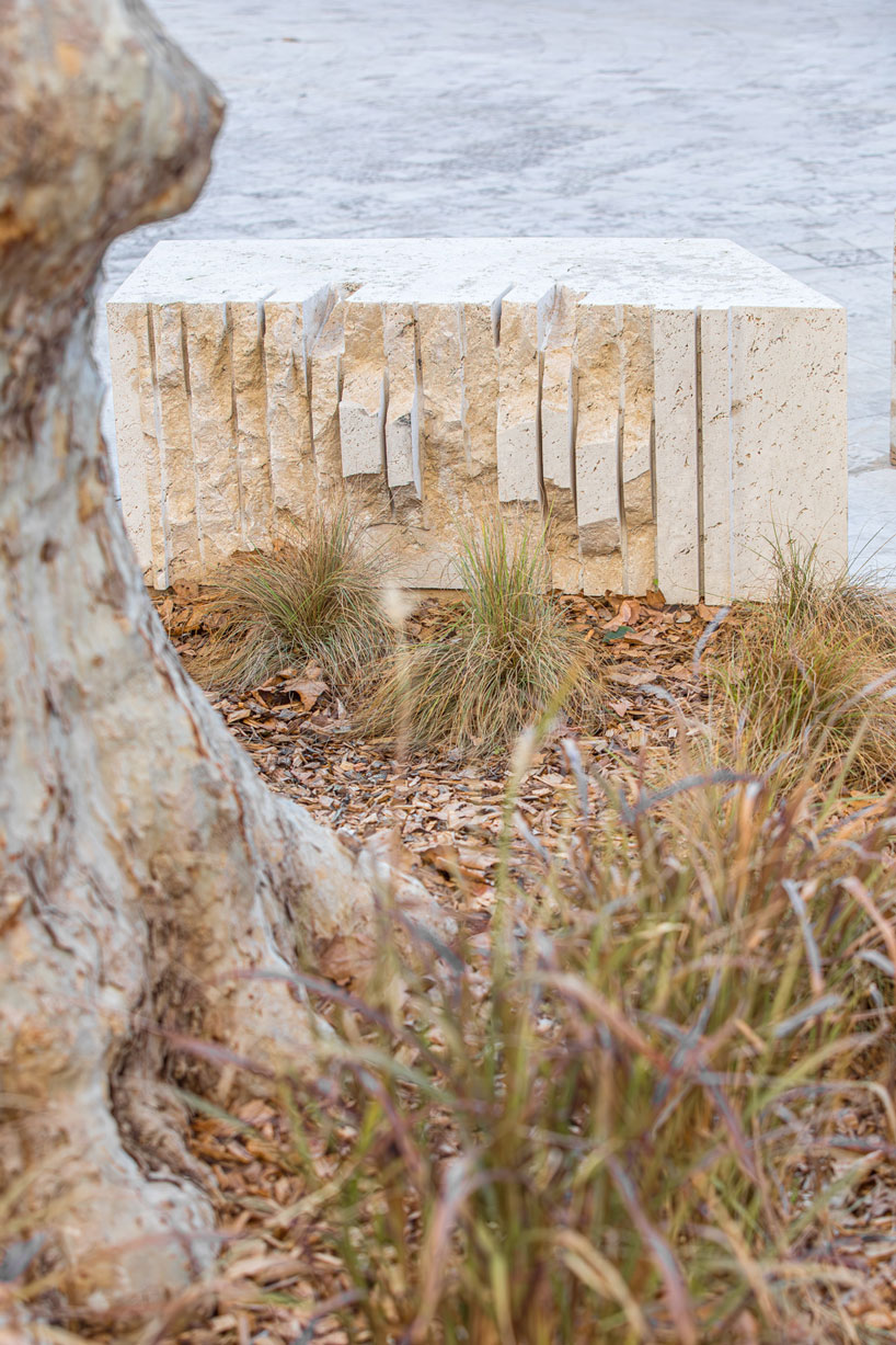 carved travertine transforms paving, furniture, and planting across spanish historic old town - 11