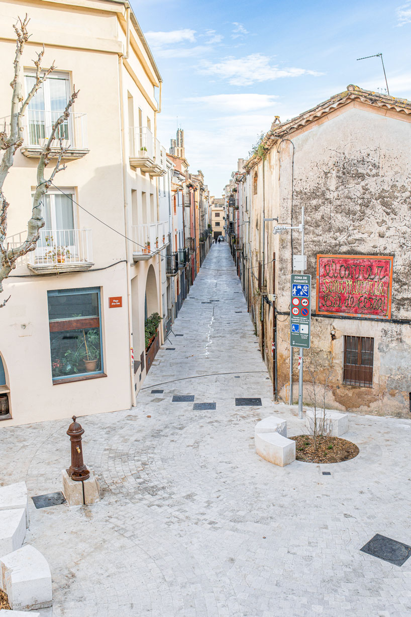 carved travertine transforms paving, furniture, and planting across spanish historic old town - 12