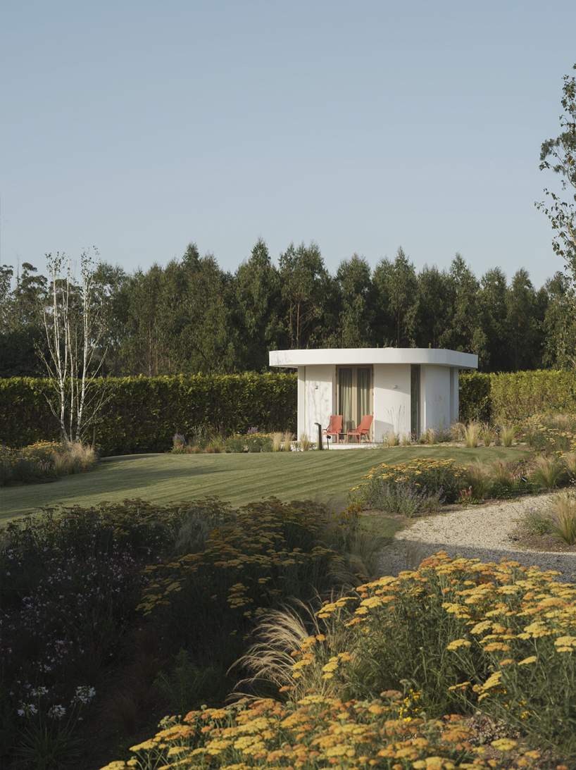 white rounded volumes form temporary stay cabins for restaurant expansion in spain