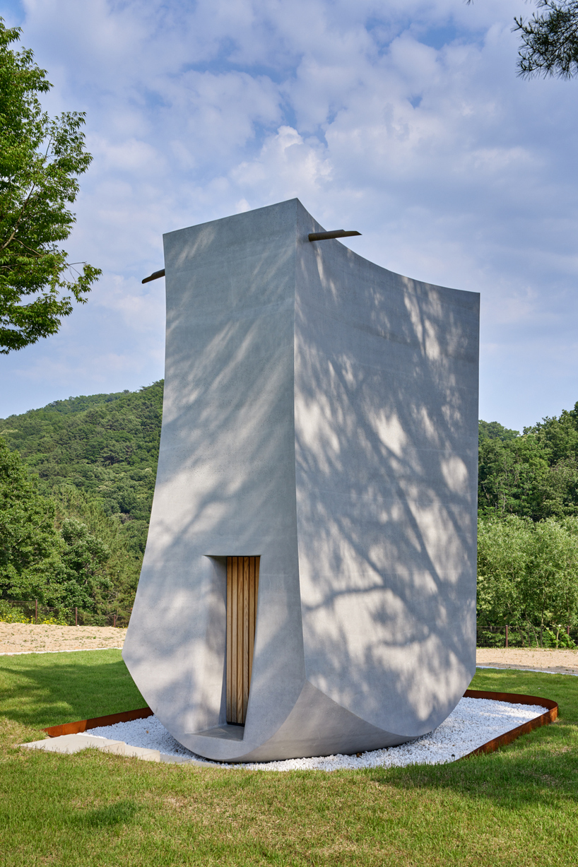monolithic chapel in south korea explores concrete's properties and nature's organic forms