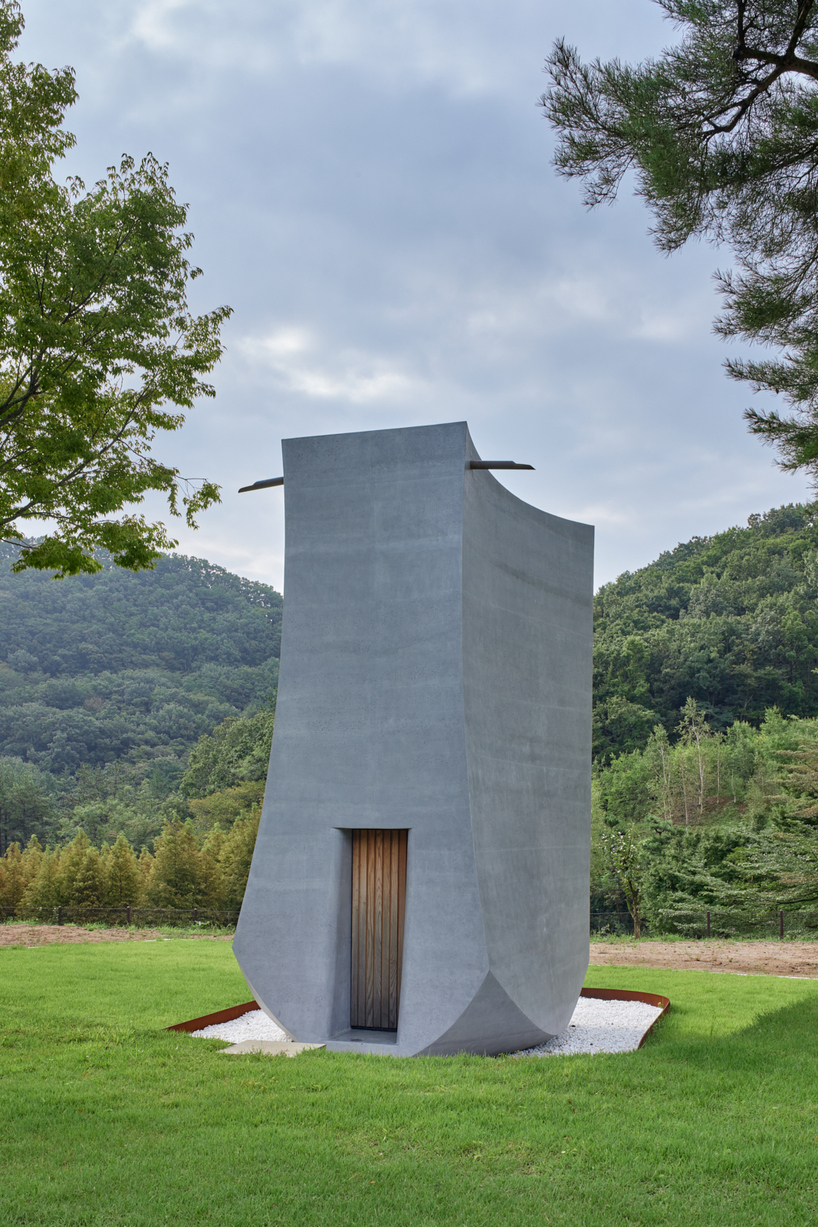 monolithic chapel in south korea explores concrete's properties and nature's organic forms