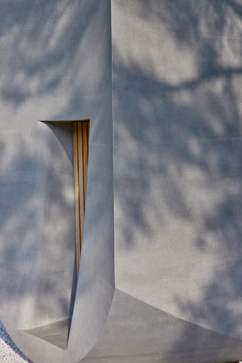 monolithic chapel in south korea explores concrete's properties and nature's organic forms