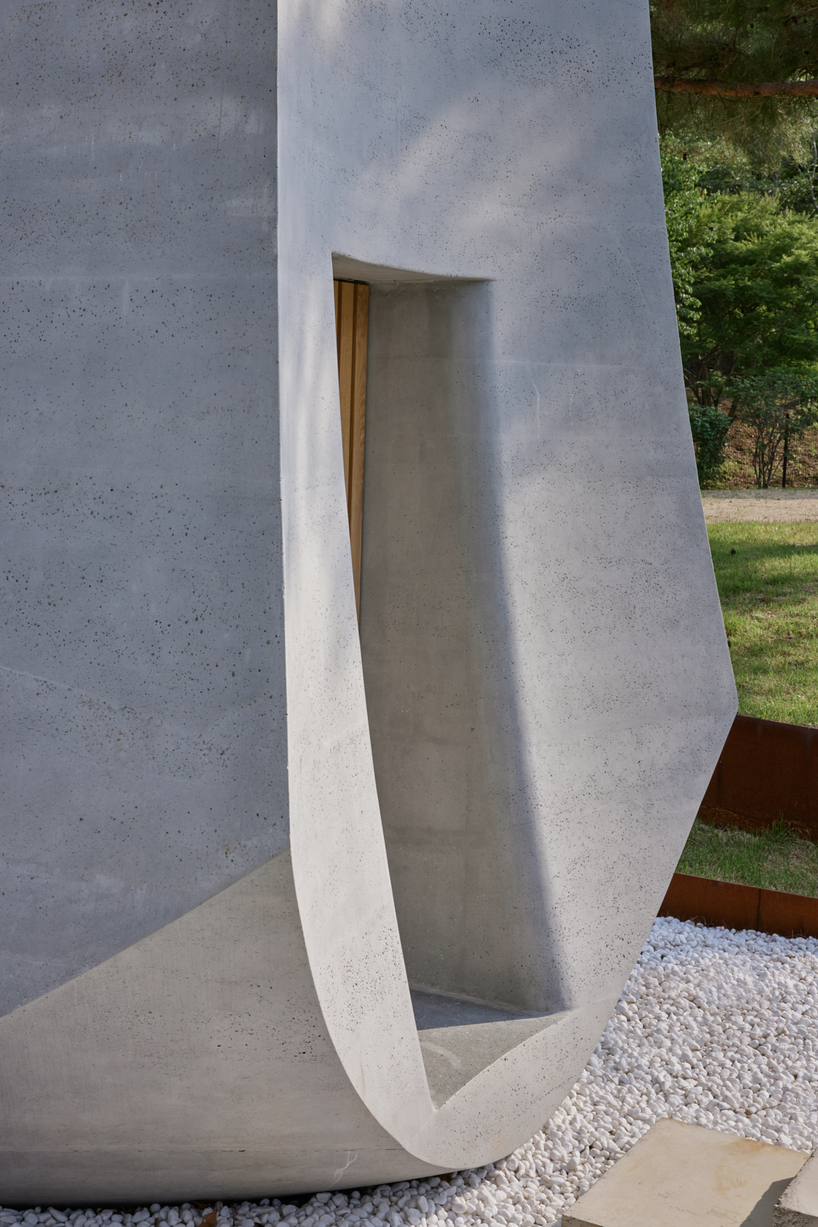 monolithic chapel in south korea explores concrete's properties and nature's organic forms