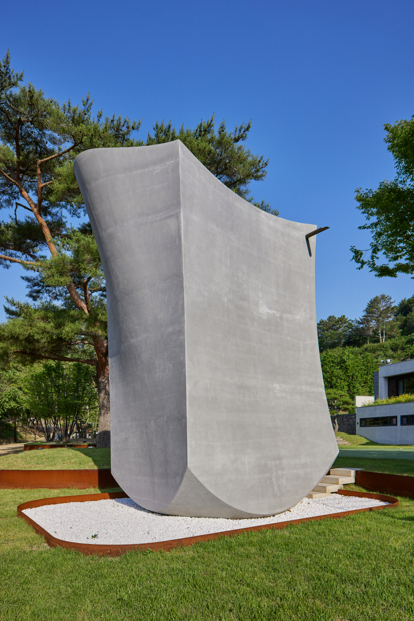 monolithic chapel in south korea explores concrete's properties and nature's organic forms