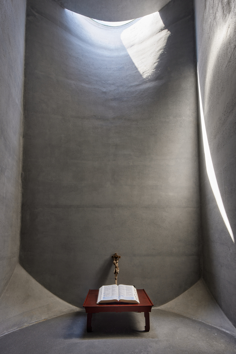 monolithic chapel in south korea explores concrete's properties and nature's organic forms