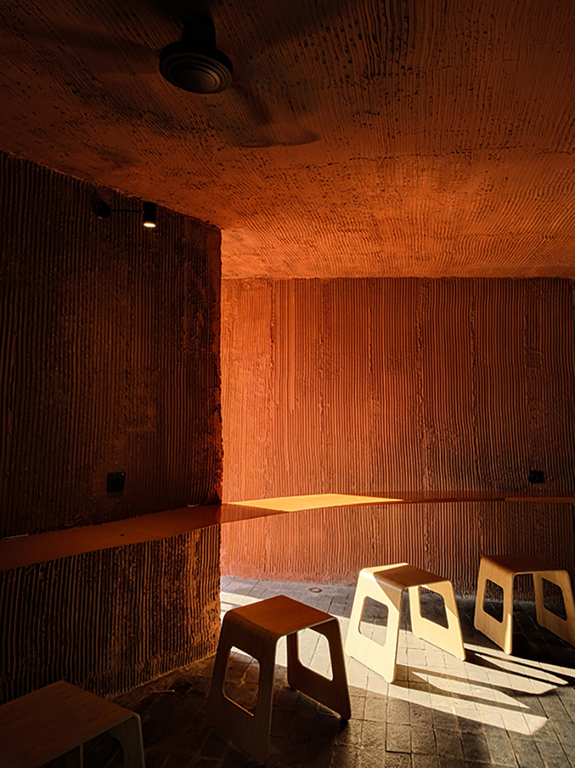 terracotta-tinted concrete district 27 coffee shop reuses old medical laboratory in indonesia