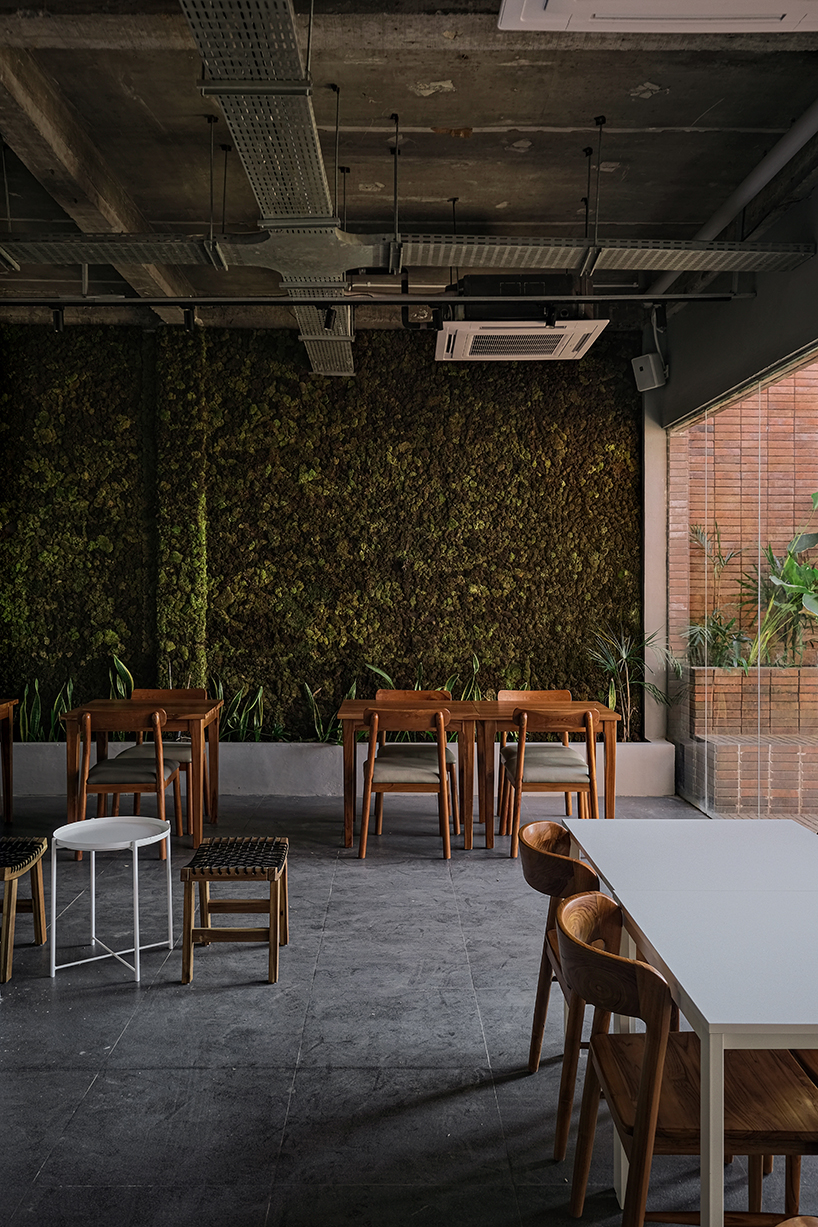 local stone, brick and terracotta screens layer across three-story gathering space in indonesia - 8