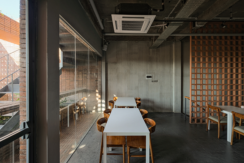 local stone, brick and terracotta screens layer across three-story gathering space in indonesia - 7