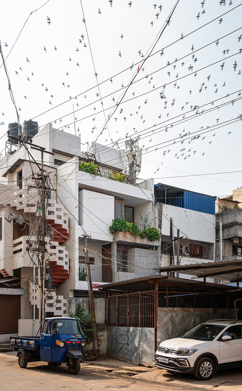 overlapping white volumes compose compact house by rahul pudale design in india