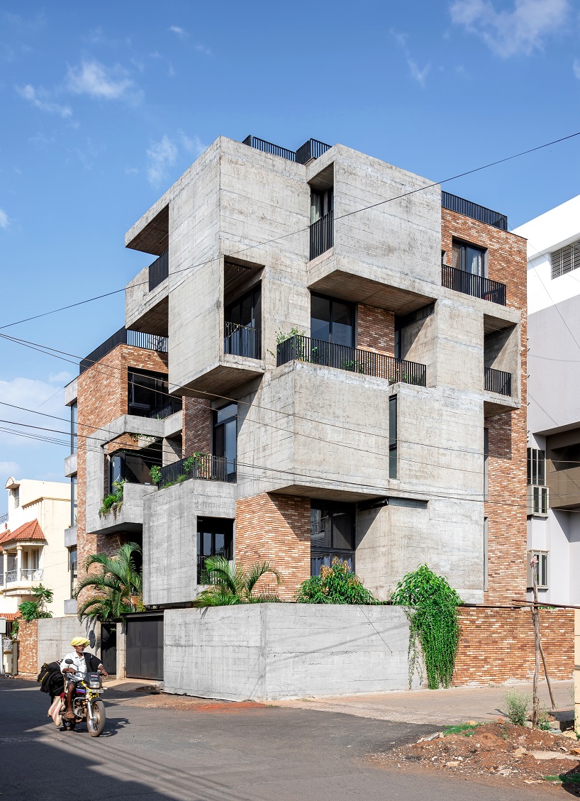 concrete and brick interplay on multi-layered residence's geometric facade by rahul pudale