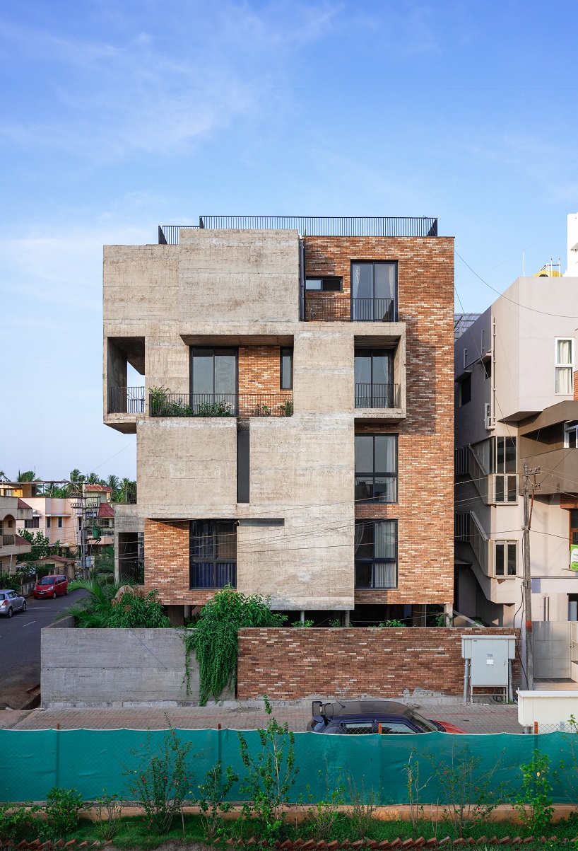 concrete and brick interplay on multi-layered residence's geometric facade by rahul pudale