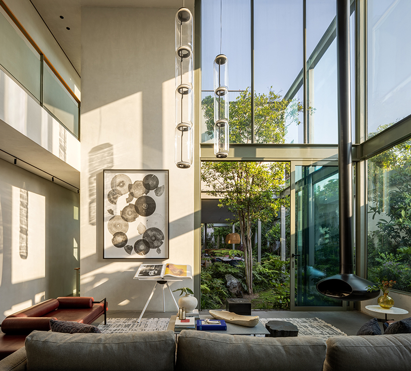 garden void softens the rigid steel and glass structure of cárpatos house in mexico city