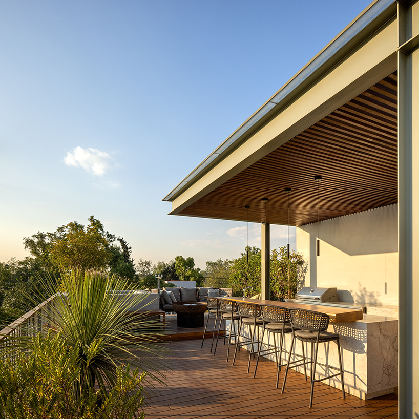garden void softens the rigid steel and glass structure of cárpatos house in mexico city