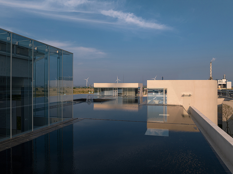 biomanufacturing facility by xing design lies under shallow water ponds in china