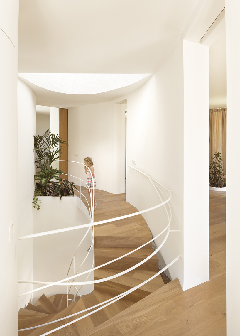 curved white volumes and verdant surroundings define house in les rotes, spain