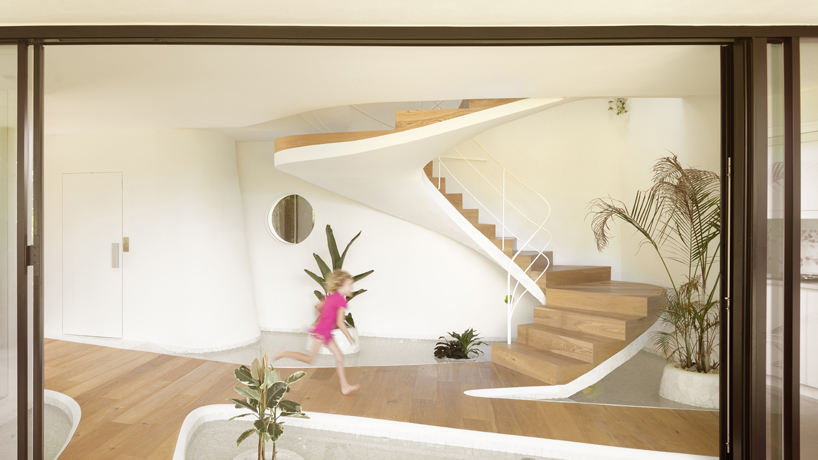 curved white volumes and verdant surroundings define house in les rotes, spain