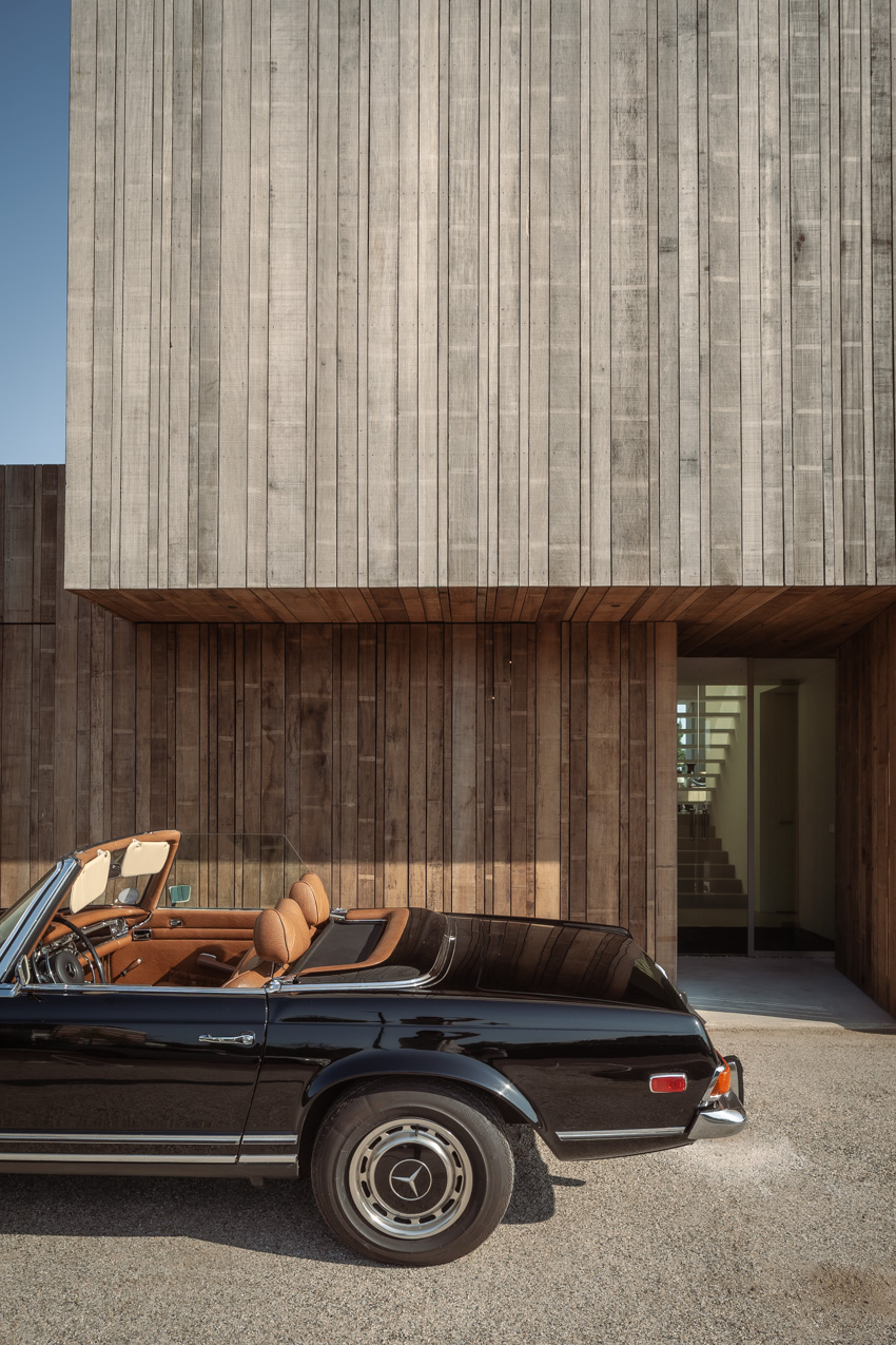 wooden cladding and lime plaster cover the solid form of villa k340 in the netherlands