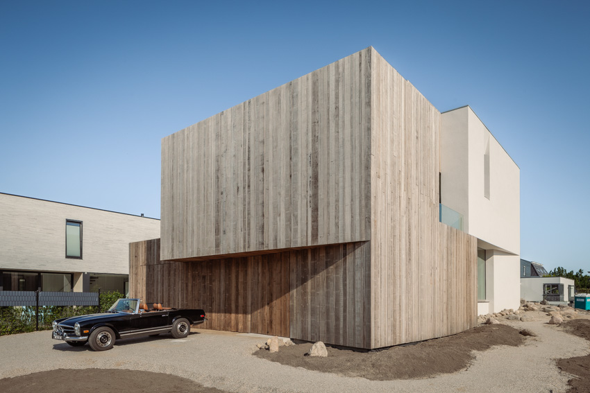 wooden cladding and lime plaster cover the solid form of villa k340 in the netherlands