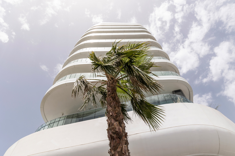 Two rippling volumes in Limassol del Mar, Cyprus combine luxury commercial and residential spaces