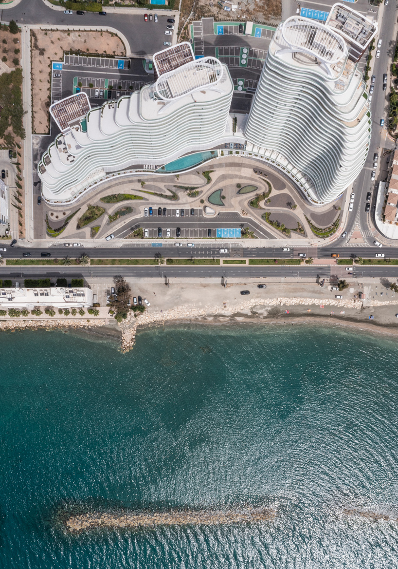 Two rippling volumes in Limassol del Mar, Cyprus combine luxury commercial and residential spaces