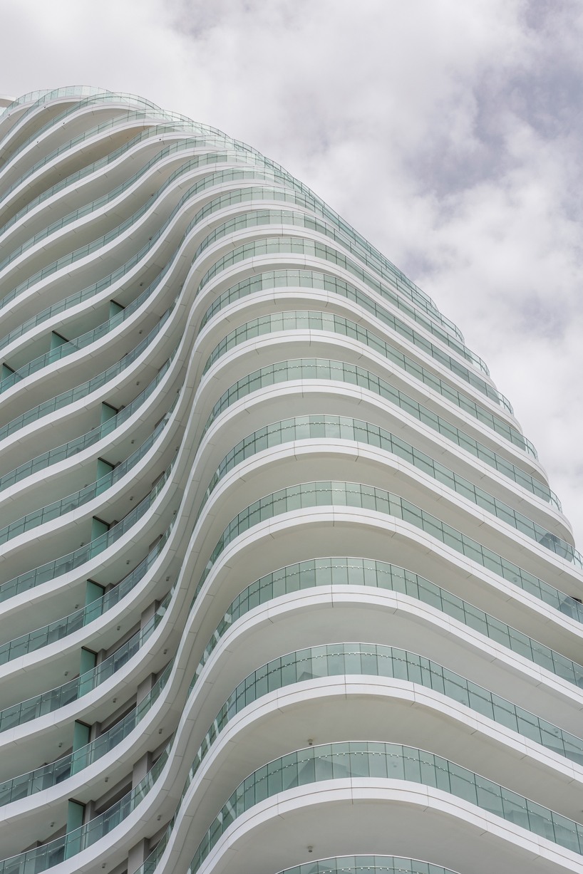 Two rippling volumes in Limassol del Mar, Cyprus combine luxury commercial and residential spaces