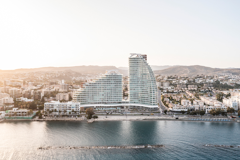 Two rippling volumes in Limassol del Mar, Cyprus combine luxury commercial and residential spaces