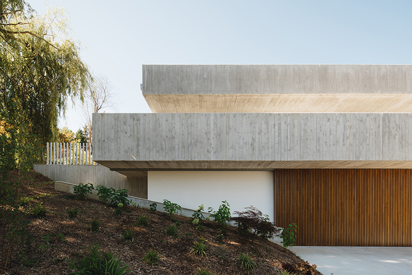 two concrete planes cantilever above the living zones of hara house in bilbao