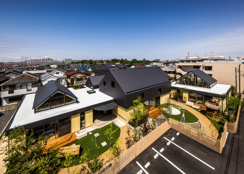 five wooden house-shaped volumes compose himawari nursery school in tokyo