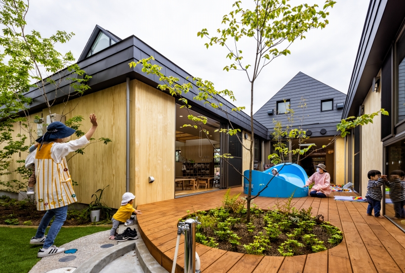 five wooden house-shaped volumes compose himawari nursery school in tokyo