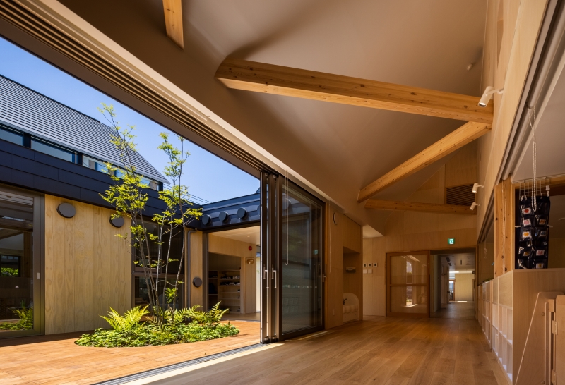 five wooden house-shaped volumes compose himawari nursery school in tokyo