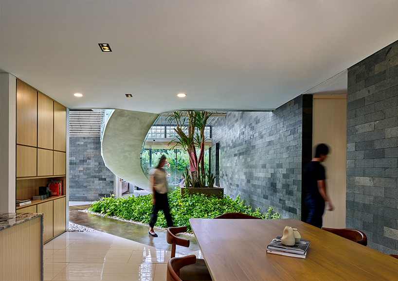 expansive gable roof hovers above RAD+ar's bernaung house in indonesia