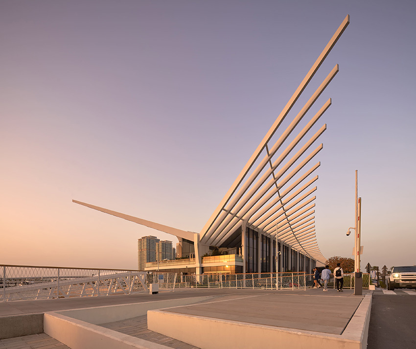 a curving steel finned roof extends over AMA's dubai harbour yacht club