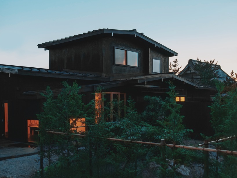 old japanese timber farmhouse transforms into modest hotel with U-shaped gardens