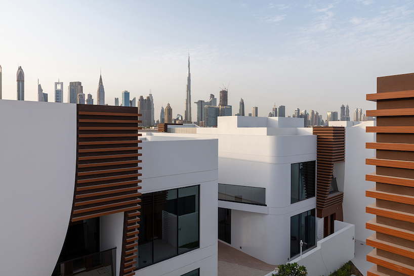 twenty-eight curved townhouses compose the fold residential complex in dubai