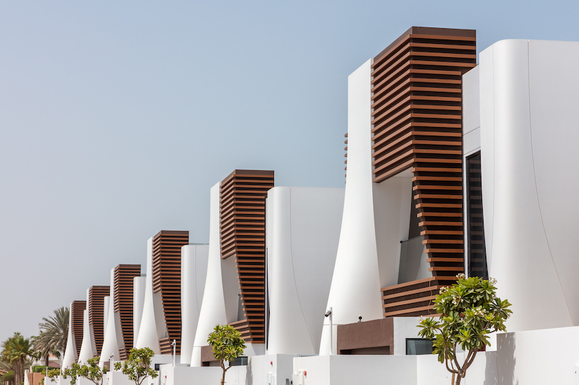 twenty-eight curved townhouses compose the fold residential complex in dubai