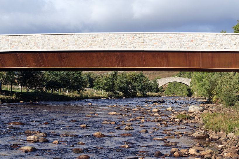 moxon's new granite and steel bridge in rural scotland stands alongside historic crossing