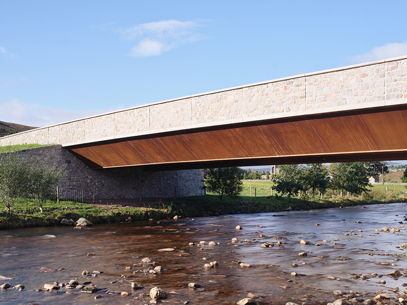 moxon's new granite and steel bridge in rural scotland stands alongside historic crossing