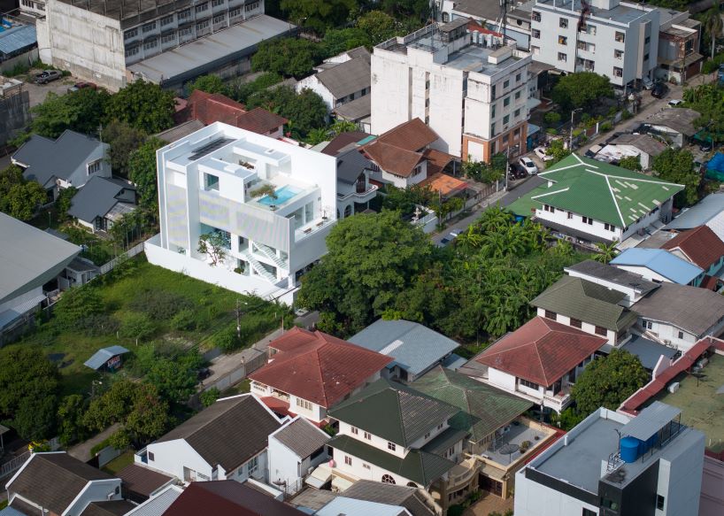 vertical white louvered surfaces enfold canvas house in bangkok
