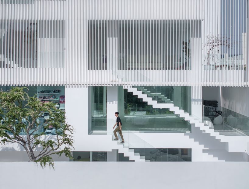 vertical white louvered surfaces enfold canvas house in bangkok