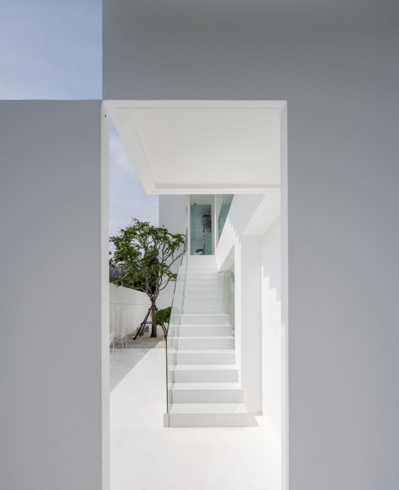 vertical white louvered surfaces enfold canvas house in bangkok